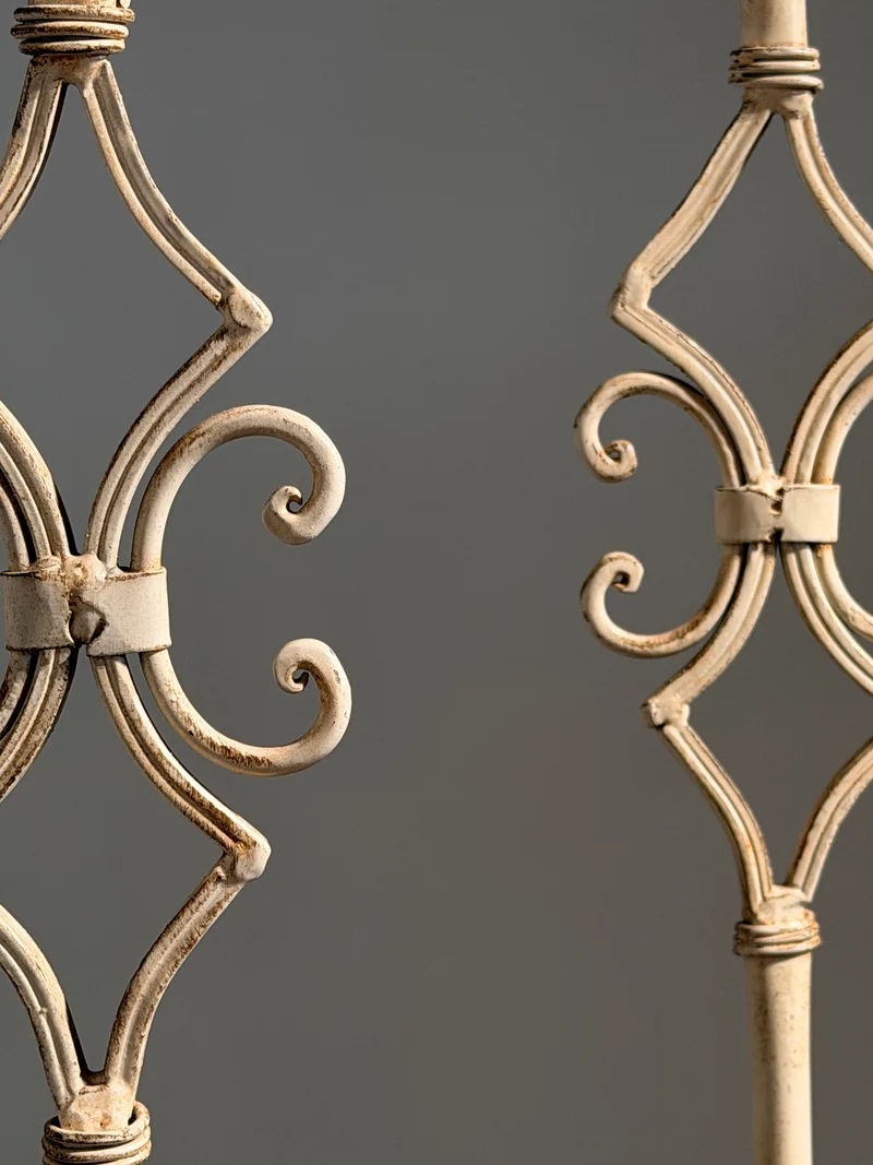 Pair of large cream-painted wrought-iron pricket candlesticks, Italy