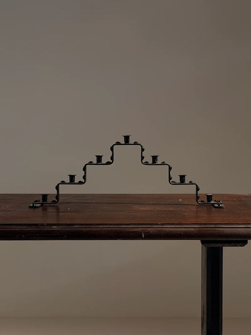 Seven-light geometric candelabra in black iron, circa 1960