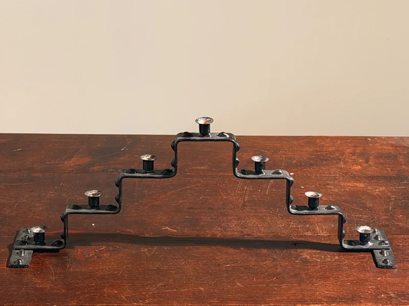 Seven-light geometric candelabra in black iron, circa 1960