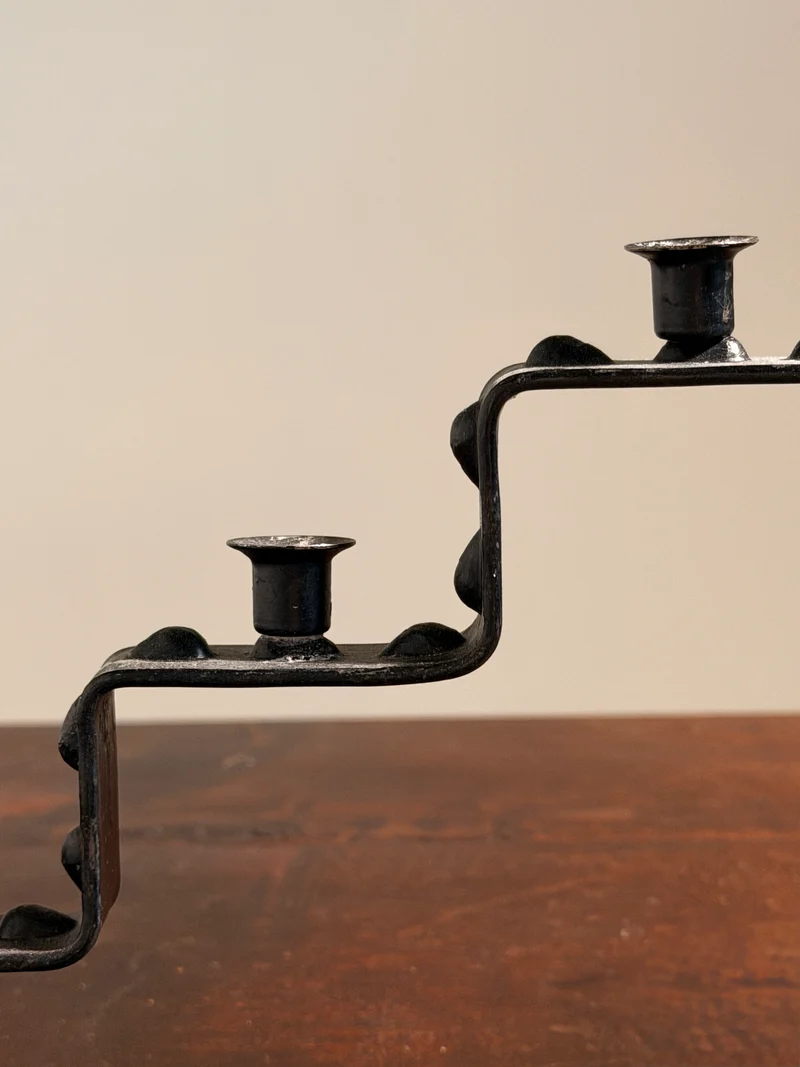 Seven-light geometric candelabra in black iron, circa 1960