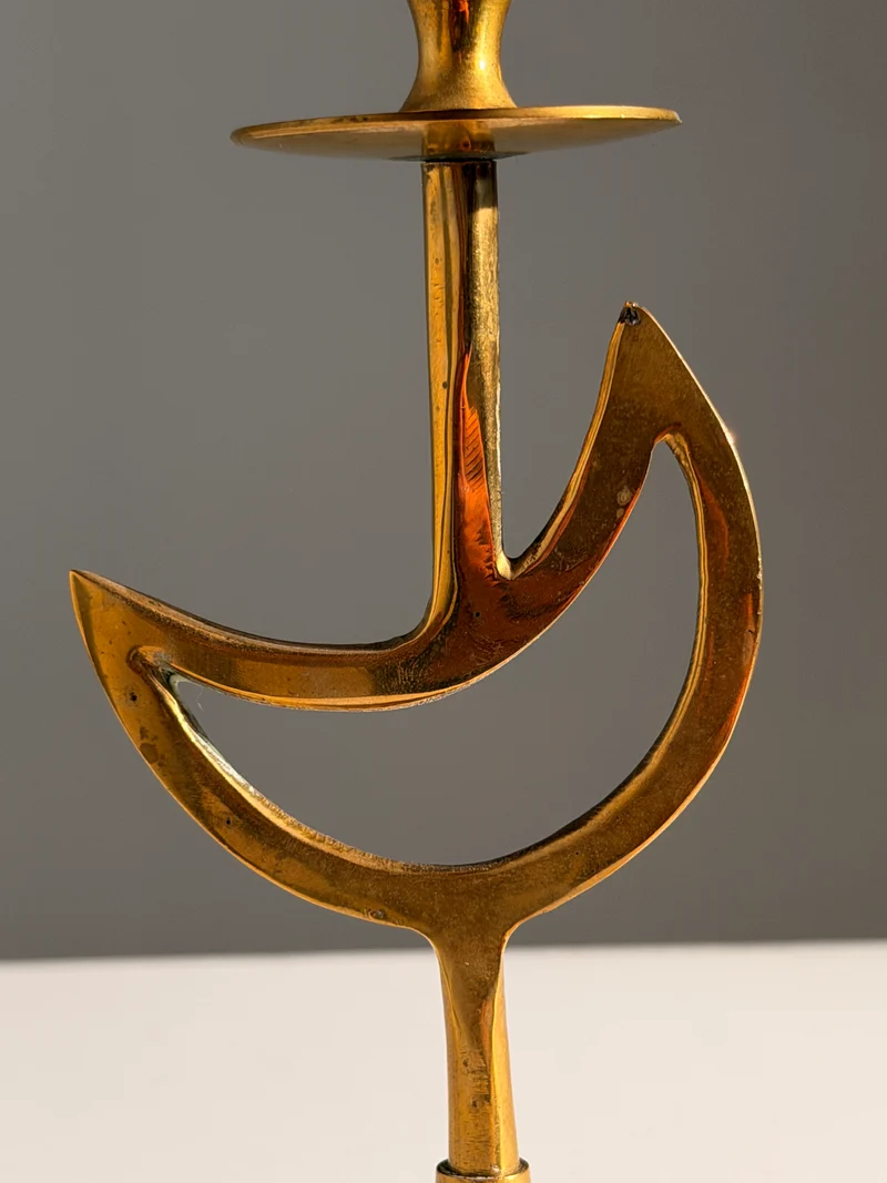 Pair of brass candlesticks with a crescent-moon motif, France, circa 1970