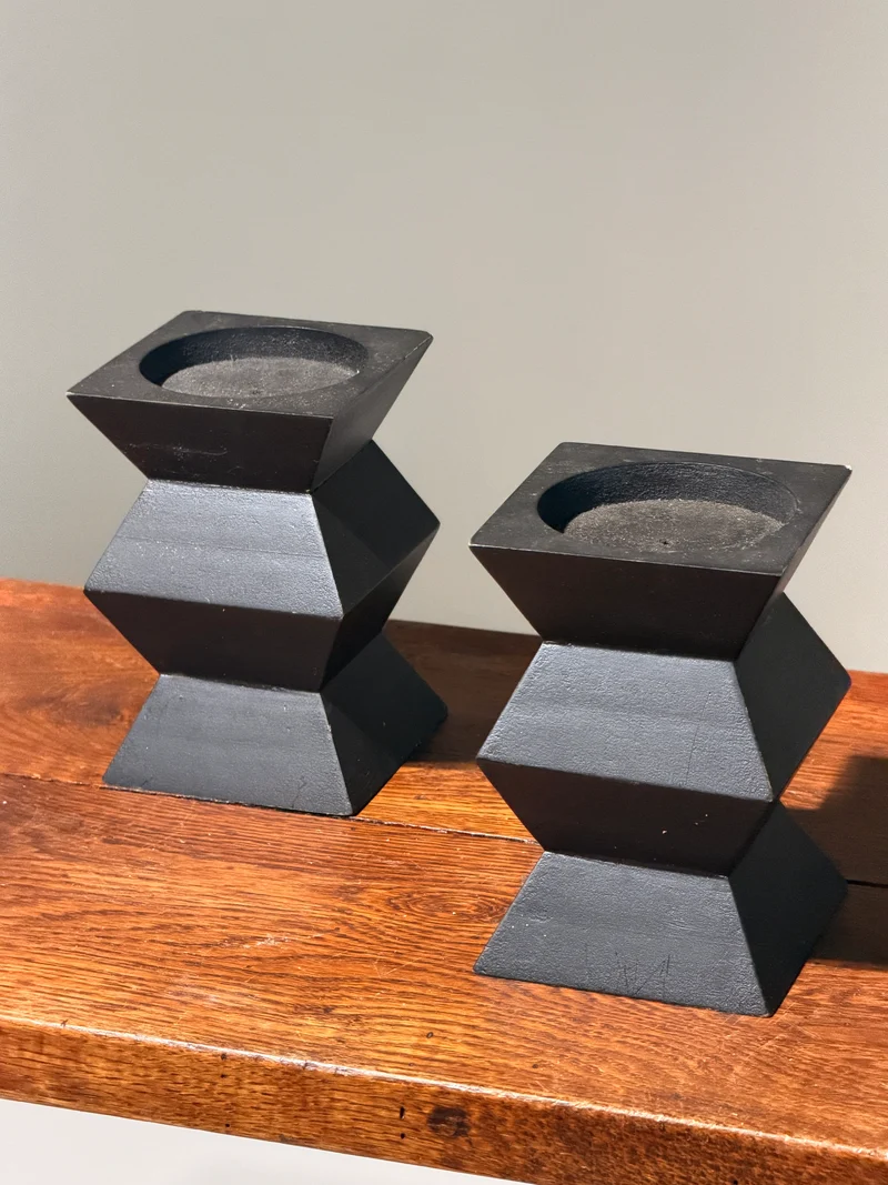 Pair of geometric black wooden candlesticks, anonymous work